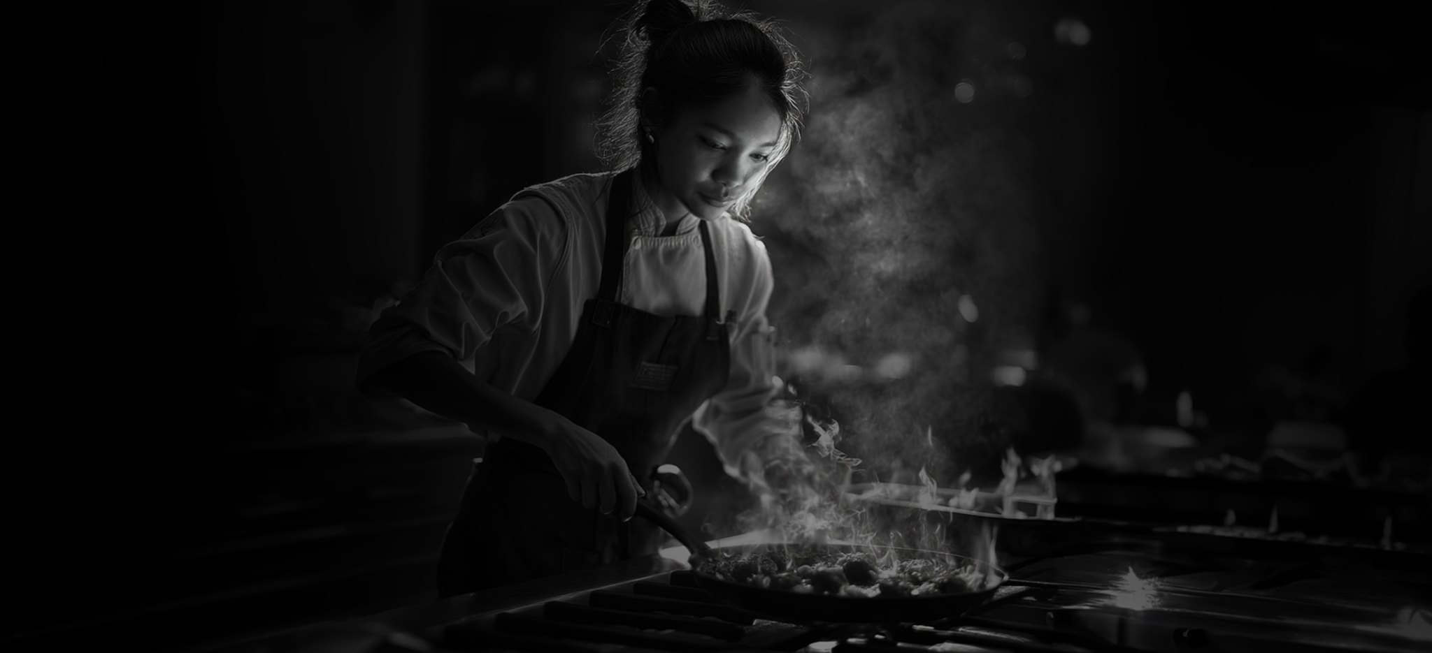 Tanya cooking over an open flame in a Melbourne kitchen